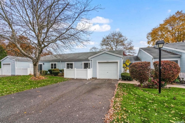 view of front of home featuring a garage and a front lawn