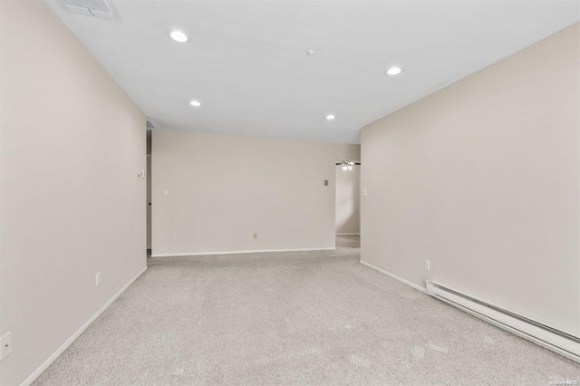 carpeted spare room with baseboard heating and ceiling fan