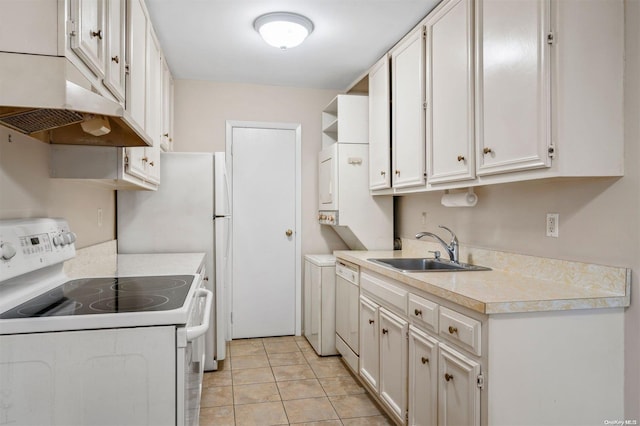 kitchen featuring white cabinetry, sink, separate washer and dryer, white appliances, and light tile patterned floors