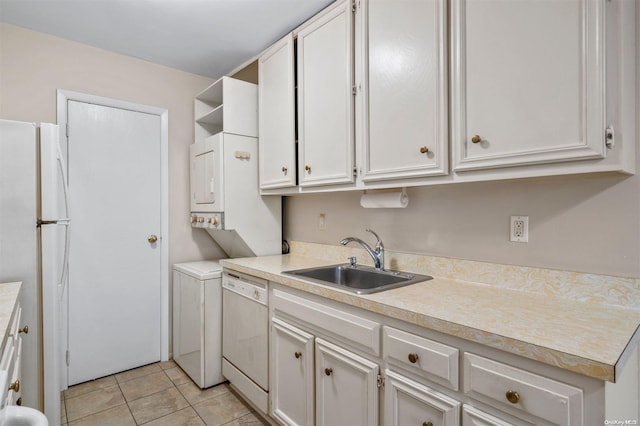 clothes washing area featuring light tile patterned floors, stacked washer / drying machine, and sink