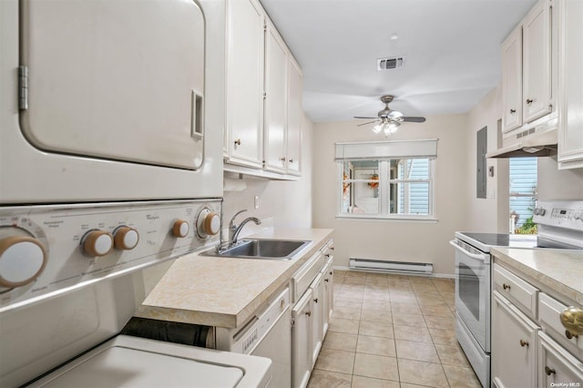 kitchen with white appliances, ceiling fan, sink, white cabinets, and stacked washer and dryer