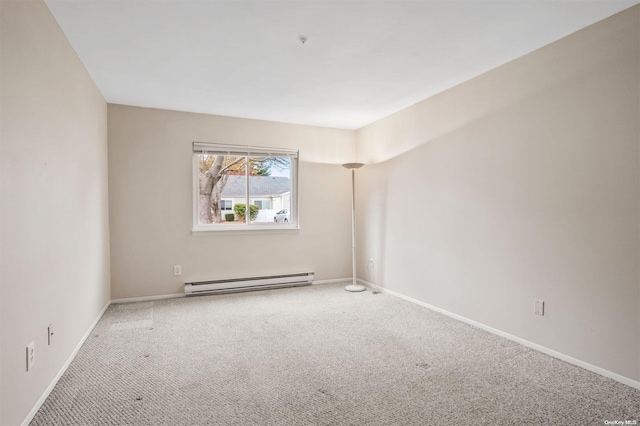 carpeted empty room featuring baseboard heating