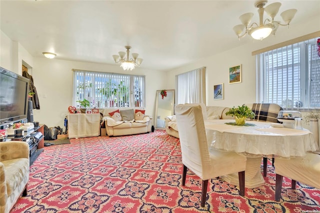 living room featuring a wealth of natural light and a notable chandelier