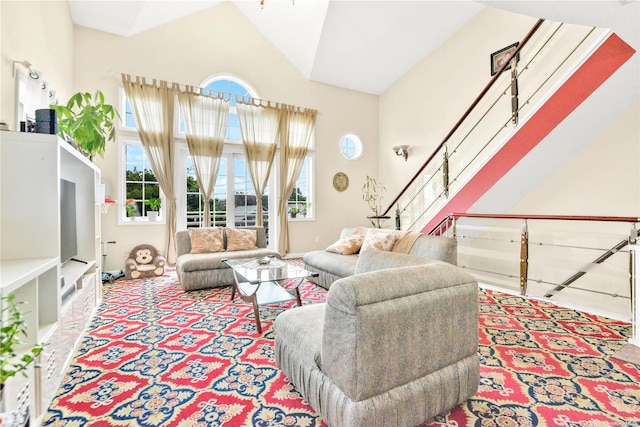 living room featuring light colored carpet and high vaulted ceiling