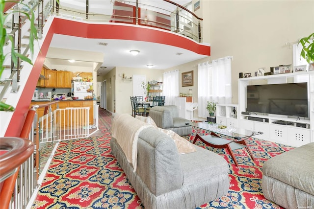 living room featuring a towering ceiling