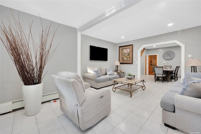 living room with light tile patterned floors and a baseboard heating unit