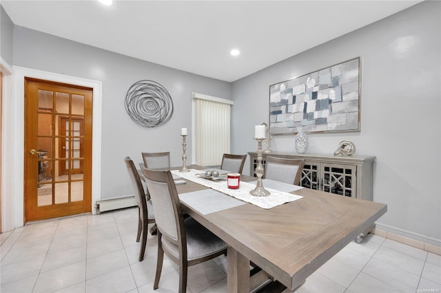 tiled dining area featuring baseboard heating