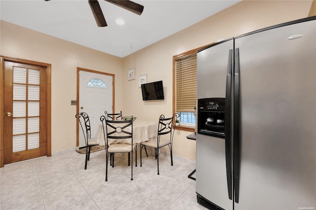 tiled dining space with ceiling fan