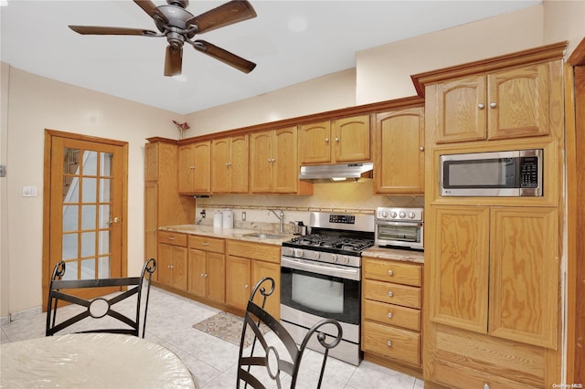 kitchen with ceiling fan, sink, backsplash, light tile patterned flooring, and appliances with stainless steel finishes