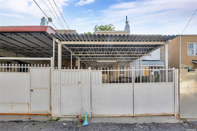 view of gate with an outbuilding