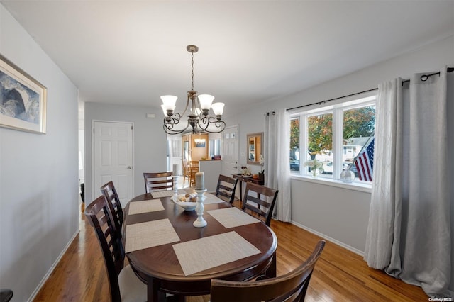 dining space with a chandelier and hardwood / wood-style flooring