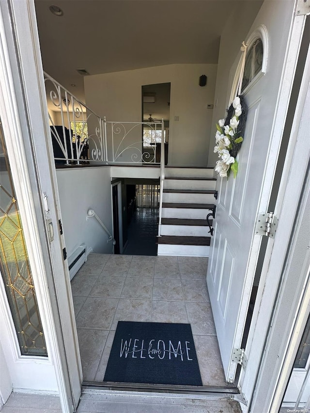 property entrance featuring a baseboard heating unit