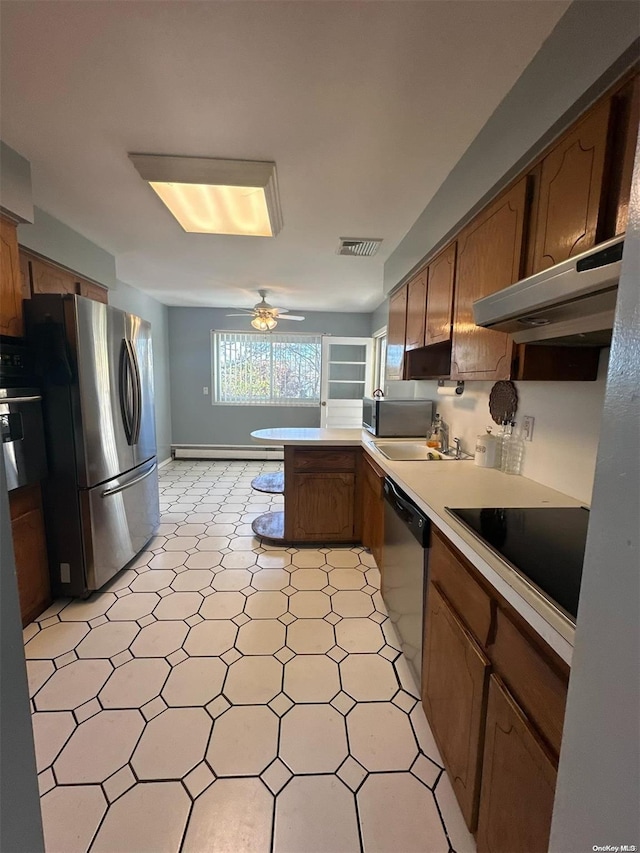 kitchen featuring exhaust hood, ceiling fan, baseboard heating, appliances with stainless steel finishes, and kitchen peninsula