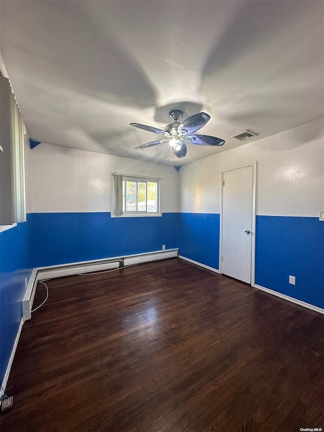 empty room featuring ceiling fan, dark wood-type flooring, and a baseboard radiator