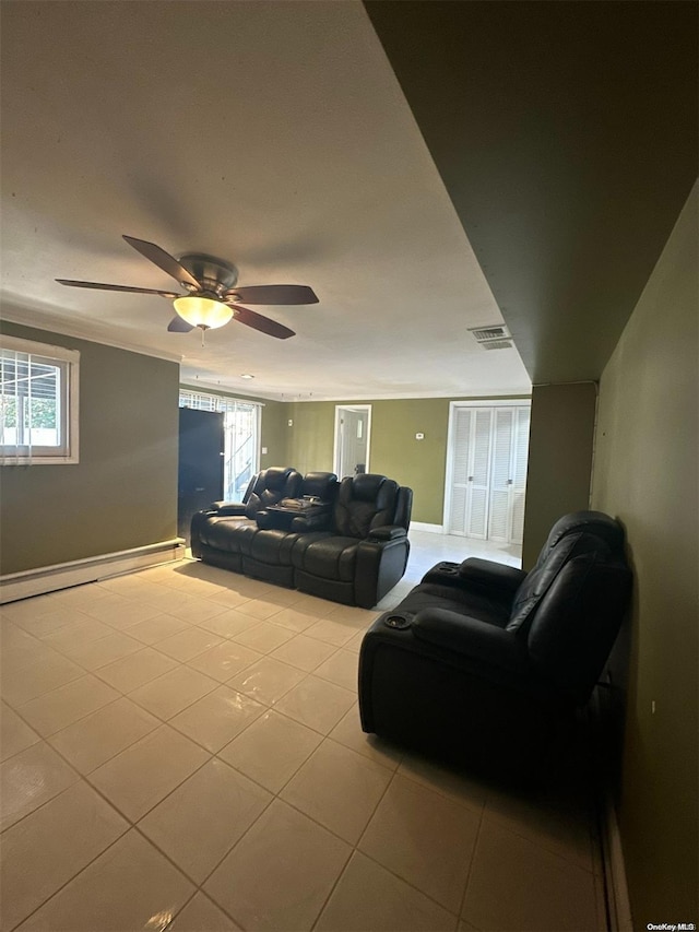 tiled living room with ceiling fan and a baseboard radiator