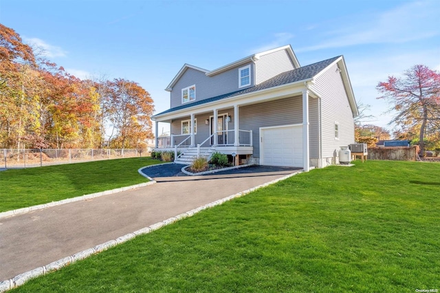 view of front of property featuring a garage, covered porch, and a front yard