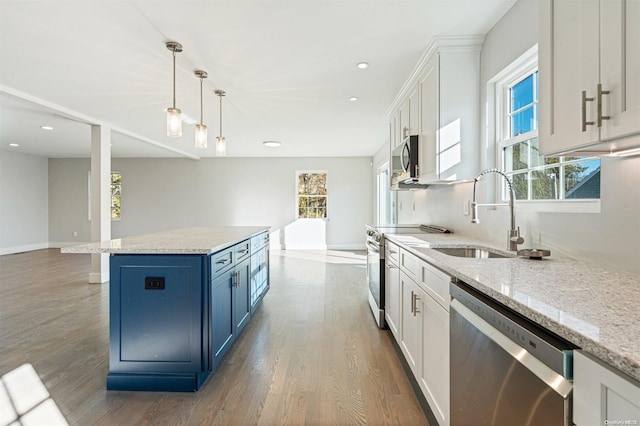 kitchen featuring white cabinets, a healthy amount of sunlight, and stainless steel appliances