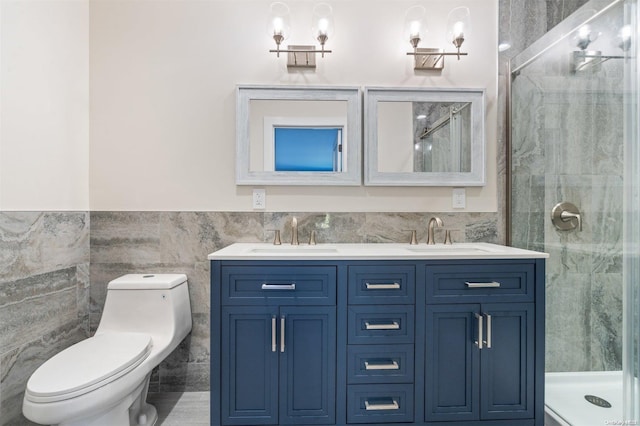 bathroom featuring vanity, a shower with shower door, tile walls, and toilet