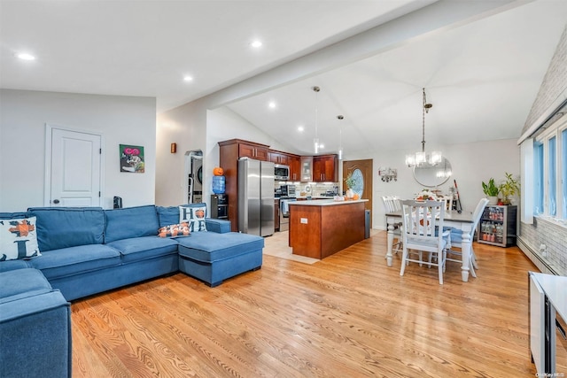 living room featuring lofted ceiling with beams and light hardwood / wood-style flooring