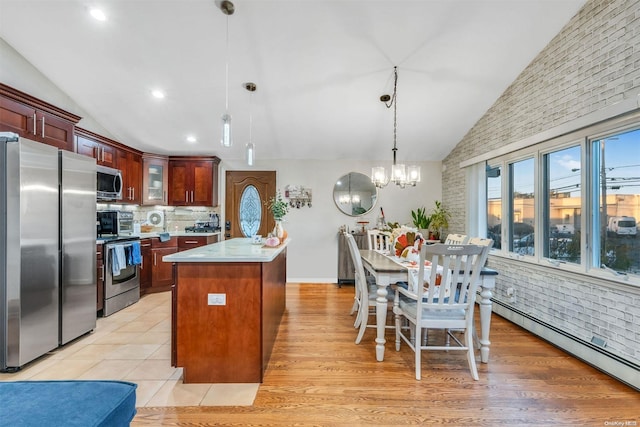 kitchen with a center island, a baseboard heating unit, hanging light fixtures, light hardwood / wood-style flooring, and stainless steel appliances