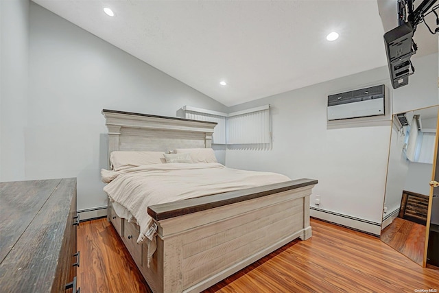 bedroom with an AC wall unit, baseboard heating, lofted ceiling, and hardwood / wood-style flooring