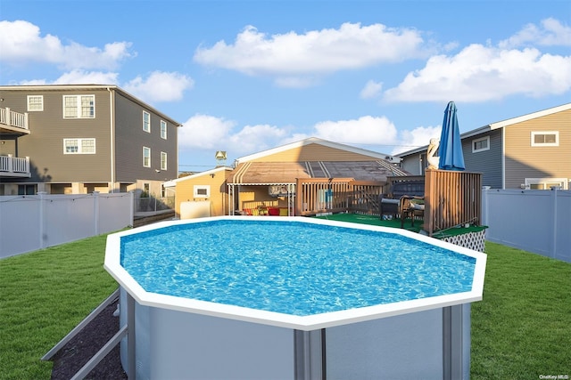 view of pool with a yard