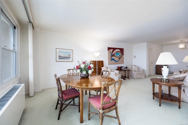 23-20 Bell Blvd Unit 5F, Bayside, NY 11360 - dining space featuring light colored carpet, radiator, and plenty of natural light