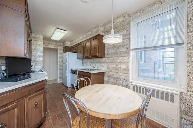 23-20 Bell Blvd Unit 5F, Bayside, NY 11360 - kitchen with radiator, brick patterned flooring, stainless steel dishwasher, light countertops, and a sink