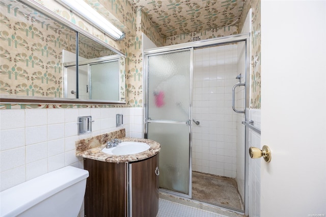 23-20 Bell Blvd Unit 5F, Bayside, NY 11360 - bathroom featuring wallpapered walls, tile walls, vanity, toilet, and a stall shower