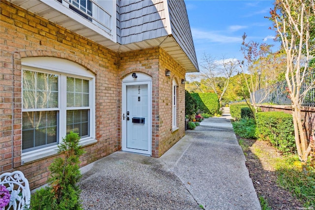 655 Middle Country Rd Unit 8D2, Coram, NY 11727 - property entrance with mansard roof, brick siding, and a patio area