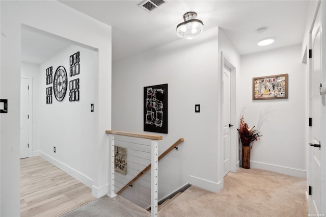 corridor featuring light colored carpet