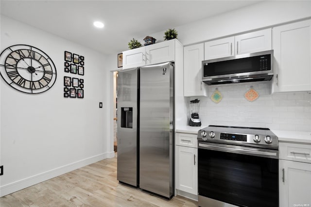 655 Middle Country Rd Unit 8D2, Coram, NY 11727 - kitchen featuring appliances with stainless steel finishes, decorative backsplash, light countertops, white cabinetry, and recessed lighting