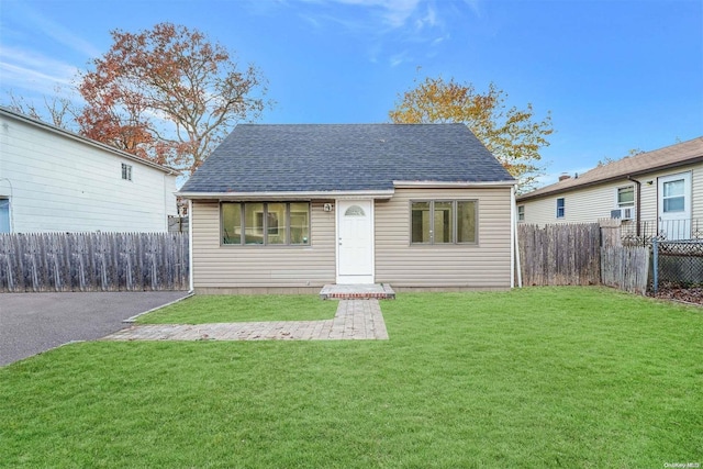 bungalow-style house featuring a front yard