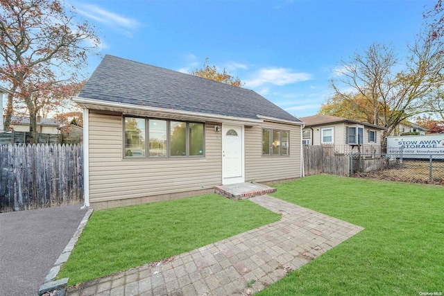 bungalow-style house with a front lawn