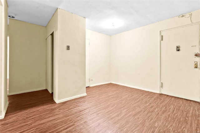 spare room with hardwood / wood-style flooring