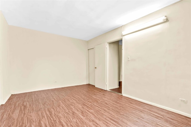 unfurnished room with light wood-type flooring