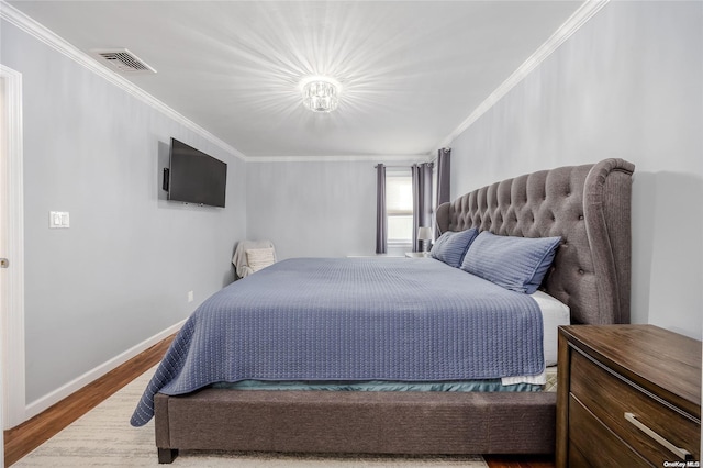 bedroom with crown molding and wood-type flooring