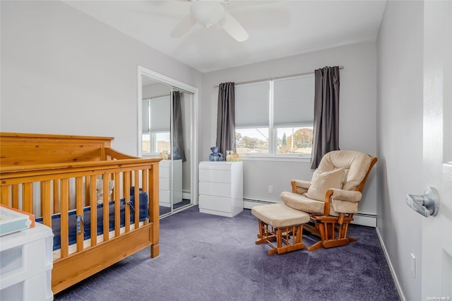 carpeted bedroom featuring ceiling fan, a closet, a nursery area, and a baseboard radiator