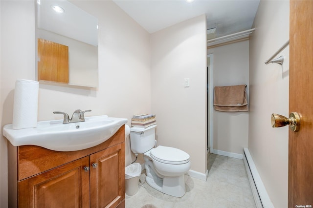 bathroom featuring vanity, toilet, and a baseboard heating unit