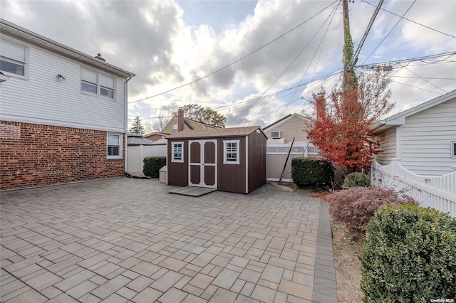 view of patio / terrace with a shed