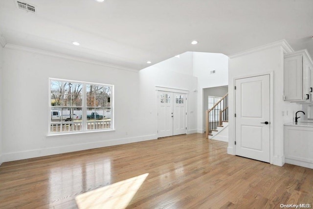 empty room featuring ornamental molding and light wood-type flooring