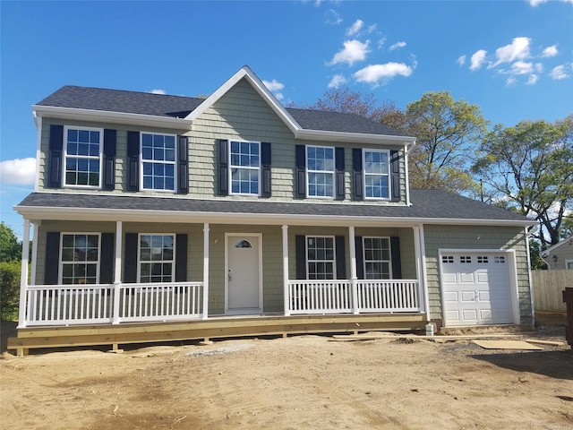 colonial inspired home with a garage and covered porch