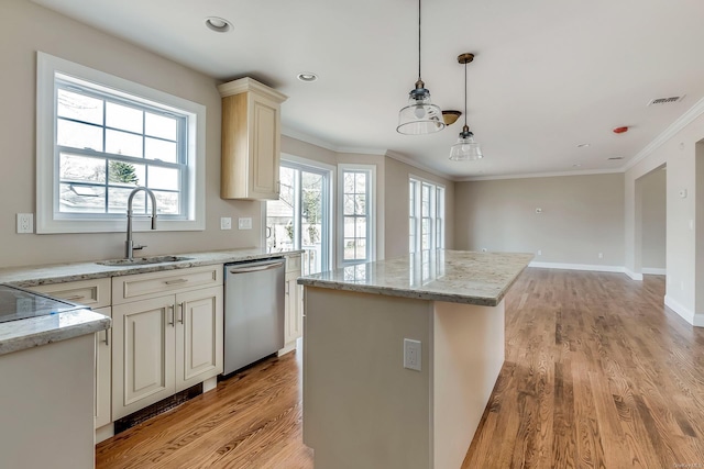 kitchen with stainless steel dishwasher, sink, decorative light fixtures, light hardwood / wood-style flooring, and a center island