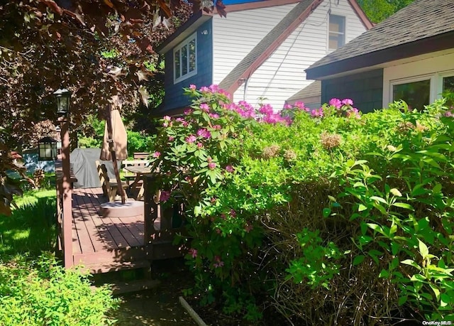 view of home's exterior featuring a wooden deck