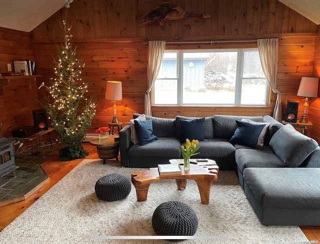 living room with hardwood / wood-style floors, wooden walls, and lofted ceiling