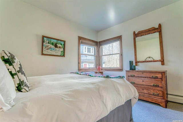 carpeted bedroom featuring a baseboard heating unit