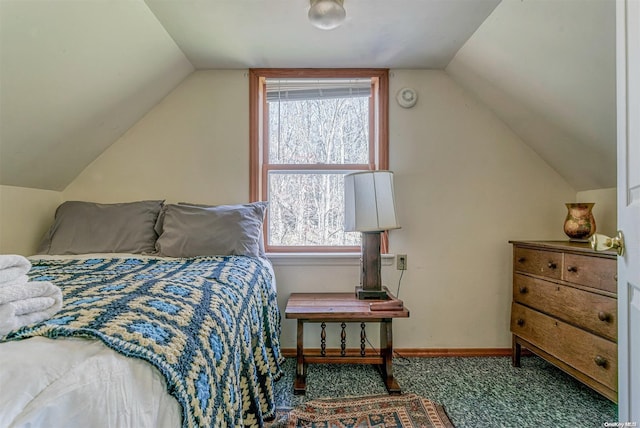 carpeted bedroom with lofted ceiling