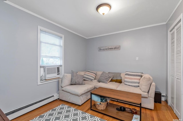 living room featuring cooling unit, hardwood / wood-style flooring, baseboard heating, and crown molding