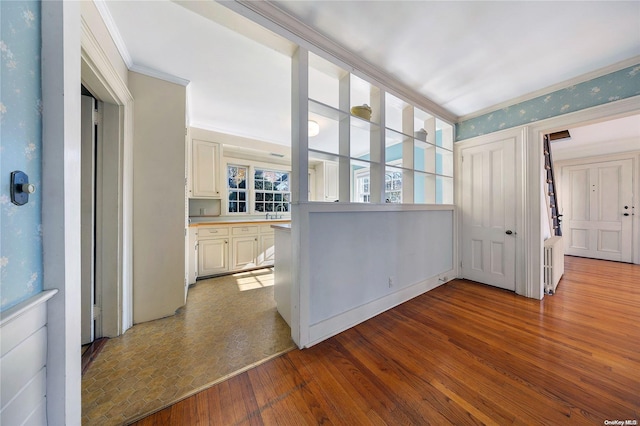 interior space with crown molding and light hardwood / wood-style floors