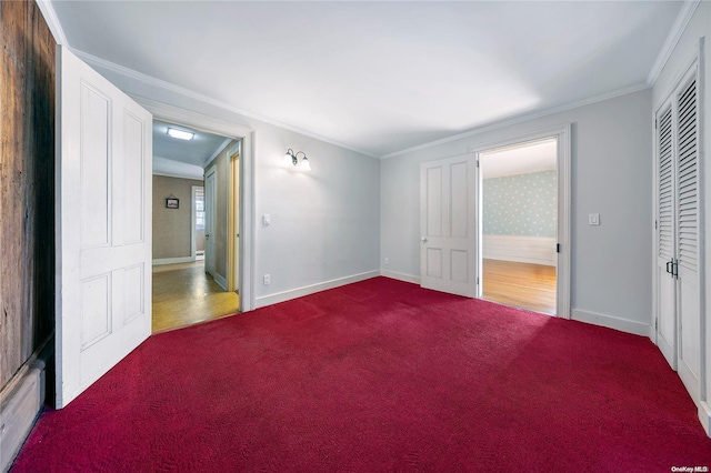 unfurnished bedroom featuring carpet flooring, a closet, and crown molding